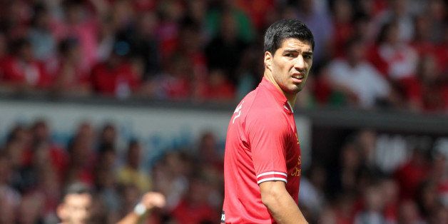 Liverpool's Uruguayan striker Luis Suarez looks on during the pre-season friendly football match between Liverpool and Olympiakos at Anfield Stadium in Liverpool, northwest England on August 3, 2013. The game is a testimonial match for Liverpool captain Steven Gerrard who recently signed a new two-year contract extension with Liverpool, the only club he has ever played for. AFP PHOTO/LINDSEY PARNABY (Photo credit should read LINDSEY PARNABY/AFP/Getty Images)