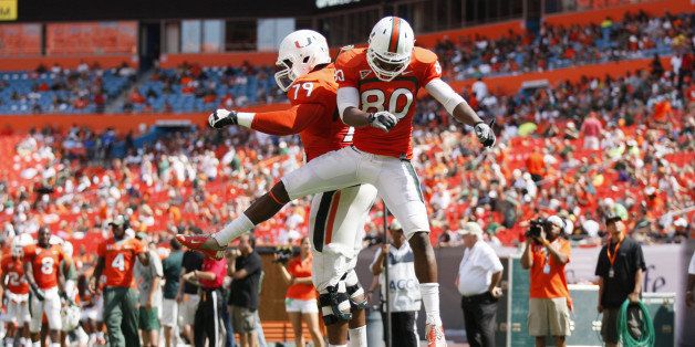 Miami players Rashawn Scott, right, and Malcolm Bunch, left, celebrate an orange team touchdown during the Hurricanes' spring football game at Sun Life Stadium Stadium in Miami, Florida, Saturday, April 13, 2013. (Gregory Castillo/Miami Herald/MCT via Getty Images)