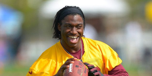 RICHMOND VA - JULY 25: Washington's quarterback Robert Griffin III (10) warms up during the Washington Redskins morning walk through at the Redskins new facility in Richmond VA, July 25, 2013. (Photo by John McDonnell/The Washington Post via Getty Images)