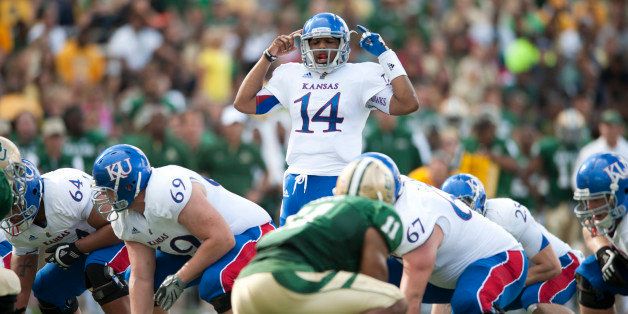 WACO, TX - NOVEMBER 3: Michael Cummings #14 of the University of Kansas Jayhawks calls a play at the line of scrimmage against the Baylor University Bears on November 3, 2012 at Floyd Casey Stadium in Waco, Texas. (Photo by Cooper Neill/Getty Images)