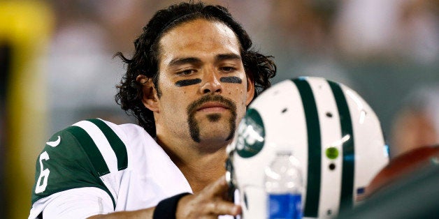 EAST RUTHERFORD, NJ - AUGUST 17: Mark Sanchez #6 of the New York Jets puts his hemet on the bench during their preseason ga