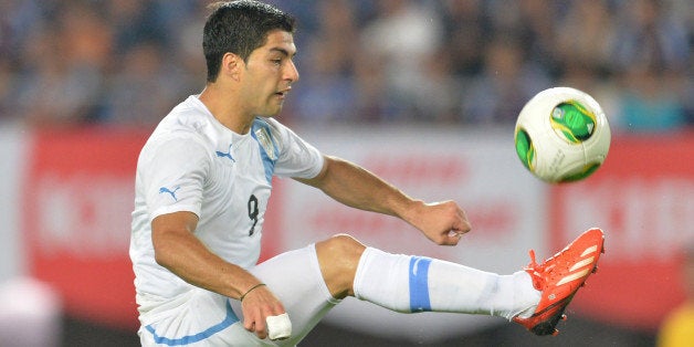 Uruguay's forward Luis Suarez attempts a shot against Japan during their international friendly football match at Miyagi Stadium in Rifu on August 14, 2013. Uruguay beat Japan 4-2. AFP PHOTO / KAZUHIRO NOGI (Photo credit should read KAZUHIRO NOGI/AFP/Getty Images)