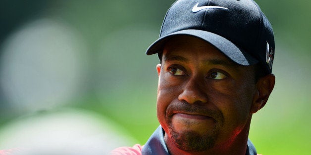 ROCHESTER, NY - AUGUST 11: Tiger Woods of the United States walks off the 18th green after an even-par 70 during the final round of the 95th PGA Championship at Oak Hill Country Club on August 11, 2013 in Rochester, New York. (Photo by Stuart Franklin/Getty Images)