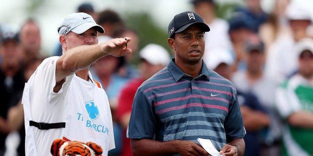 JERSEY CITY, NJ - AUGUST 23: Tiger Woods of the United States speaks with his caddie, Joe LaCava, on the second tee during th