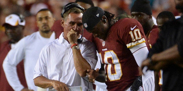 LANDOVER - AUGUST 19: Washington Redskins head coach Mike Shanahan talks with Washington Redskins quarterback Robert Griffin III (10) in the sidelines during the game between the Washington Redskins and the Pittsburgh Steelers at FedEx Field on Monday, August 19, 2013. (Photo by Toni L. Sandys/The Washington Post via Getty Images)