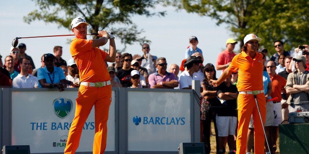 JERSEY CITY, NJ - AUGUST 25: Rickie Fowler of the United States (R) and Jonas Blixt of Sweden (L) stand on the 13th tee duri