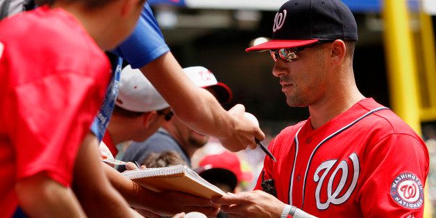 MILWAUKEE, WI - AUGUST 4: Ian Desmond #20 of the Washington Nationals signs autographs before the start of a game against the Milwaukee Brewers at Miller Park on August 4, 2013 in Milwaukee, Wisconsin. (Photo by Mark Hirsch/Getty Images)