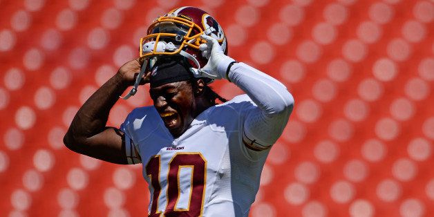 LANDOVER, MD - AUGUST 24: Quarterback Robert Griffin III #10 of the Washington Redskins takes off his helmet before playing the Buffalo Bills during a preseason game at FedExField on August 24, 2013 in Landover, Maryland. (Photo by Patrick Smith/Getty Images)