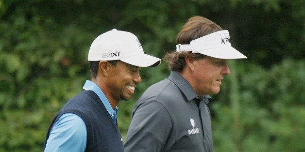 NORTON, MA - AUGUST 30: Tiger Woods and Phil Mickelson walked along the 13th fairway during the opening round of Deutsche Bank Championship at TPC Boston in Norton, Friday, Aug. 30, 2013. (Photo by Wendy Maeda/The Boston Globe via Getty Images)