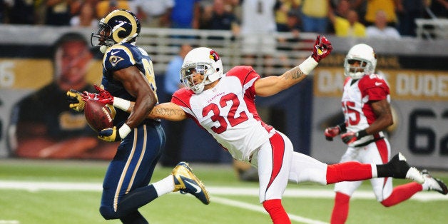 ST. LOUIS, MO - SEPTEMBER 8: Safety Tyrann Mathieu #32 of the Arizona Cardinals strips the ball from tight end Jared Cook #89 of the St. Louis Rams at the Edward Jones Dome on September 8, 2013 in St. Louis, Missouri. (Photo by Michael Thomas/Getty Images)