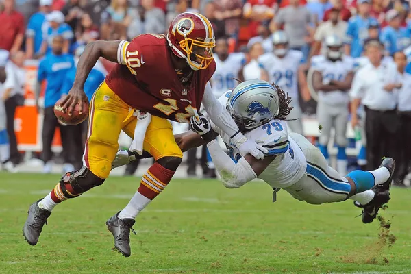 Washington Redskins quarterback Robert Griffin III (10) sprints down the  sideline for a touchdown as Minnesota Vikings free safety Harrison Smith  (22) makes a diving attempt to tackle him during the second