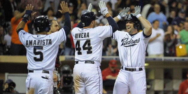 SAN DIEGO, CA - SEPTEMBER 25: Chris Robinson #8 of the San Diego Padres, right, is congratulated by Rene Rivera #44, and Alexi Amarista #5 after he hit a three-run homer during the eighth inning of a baseball game against the Arizona Diamondbacks at Petco Park on September 25, 2013 in San Diego, California. The hit was Robinson's first major league hit. (Photo by Denis Poroy/Getty Images)