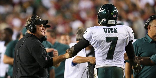 LANDOVER, MD - SEPTEMBER 09: Head coach Chip Kelly of the Philadelphia Eagles smiles as he bumps fists with quarterback Michael Vick #7 in the first half against the Washington Redskins at FedExField on September 9, 2013 in Landover, Maryland. (Photo by Rob Carr/Getty Images)