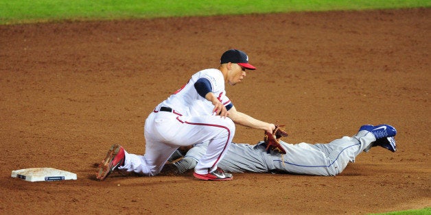 ATLANTA, GA - OCTOBER 04: Andrelton Simmons #19 of the Atlanta Braves tags out Dee Gordon #9 of the Los Angeles Dodgers as he attempts to steal second base in the ninth inning during Game Two of the National League Division Series at Turner Field on October 4, 2013 in Atlanta, Georgia. (Photo by Scott Cunningham/Getty Images)