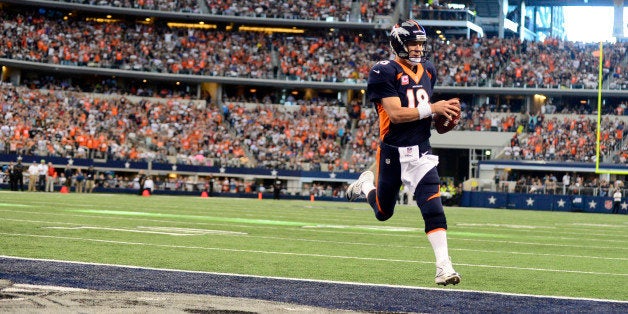 ARLINGTON, TX - OCTOBER 6: Peyton Manning (18) of the Denver Broncos rushes for a touchdown untouched by the Dallas Cowboys d