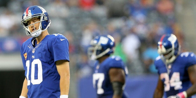 EAST RUTHERFORD, NJ - OCTOBER 06: Eli Manning #10 of the New York Giants walks off the field after throwing an interception