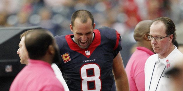 HOUSTON, TX - OCTOBER 13: Matt Schaub #8 of the Houston Texans grimmaces in pain as he is treated on the sidelines for an injury during the game against the St. Louis Rams at Reliant Stadium on October 13, 2013 in Houston, Texas. (Photo by Bob Levey/Getty Images)