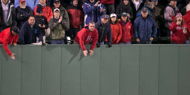 BOSTON - OCTOBER 23: Fans cheer in the bleachers in the 9th inning of Game One of the 2013 Major League Baseball World Series between the St. Louis Cardinals and Boston Red Sox at Fenway Park, Oct. 23, 2013. (Photo by Stan Grossfeld/The Boston Globe via Getty Images)