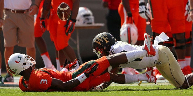 MIAMI GARDENS, FL - OCTOBER 26: Stacy Coley #3 of the Miami Hurricanes makes a catch against Merrill Noel #7 of the Wake For