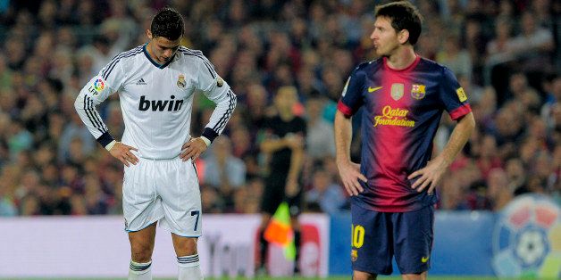 Real Madrid's Portuguese forward Cristiano Ronaldo (L) reacts in front Barcelona's Argentinian forward Lionel Messi (R) during the Spanish League Clasico football match FC Barcelona vs Real Madrid CF on October 7, 2012 at the Camp Nou stadium in Barcelona. AFP PHOTO/ JOSEP LAGO (Photo credit should read JOSEP LAGO/AFP/GettyImages)