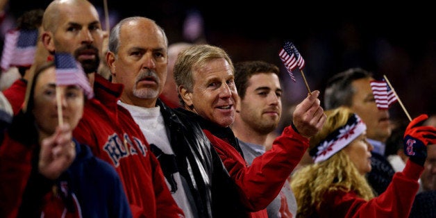 BOSTON, MA - OCTOBER 23: Fans stand during the seventh inning stretch in Game One of the 2013 World Series between the Boston