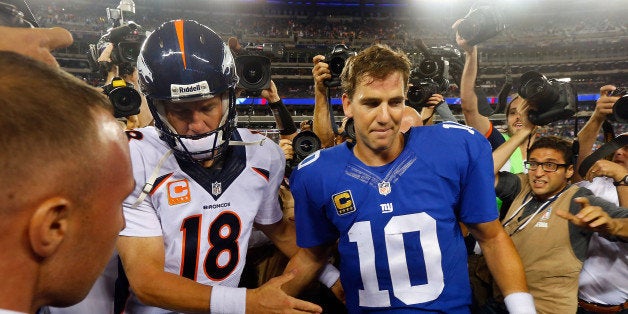 EAST RUTHERFORD, NJ - SEPTEMBER 15: (NEW YORK DAILIES OUT) Quarterbacks Peyton Manning #18 of the Denver Broncos and Eli Manning #10 of the New York Giants meet after their game on September 15, 2013 at MetLife Stadium in East Rutherford, New Jersey. The Broncos defeated the Giants 41-23. (Photo by Jim McIsaac/Getty Images) 