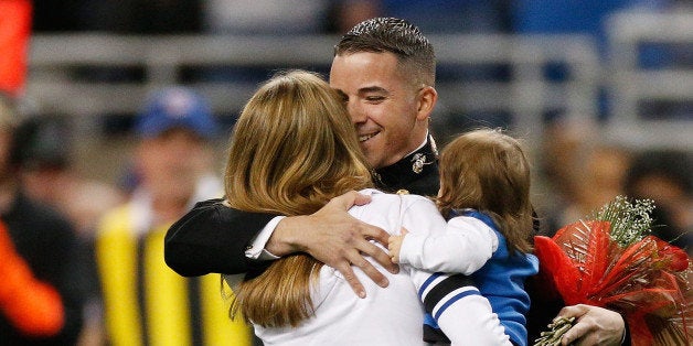 DETROIT, MI - NOVEMBER 24: As part of the team's annual 'Salute to Service' game, the Detroit Lions welcomed Michigan native, Marine Captain Josh Munsee and his family for a surprise on-field homecoming between the first and second quarter of the game against the Tampa Bay Buccaneers at Ford Field on November 24, 2013 in Detroit, Michigan. (Photo by Gregory Shamus/Getty Images)