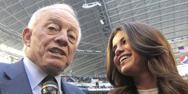 Dallas Cowboys owner Jerry Jones and singer Selena Gomez appear on the sideline before the game between the Dallas Cowboys and the Minnesota Vikings in Arlington, Texas, Sunday, November 3, 2013. Gomez will perform in the Salvation Army show during halftime of the Cowboys game on Thanksgiving Day. (Ron T. Ennis/Fort Worth Star-Telegram/MCT via Getty Images)