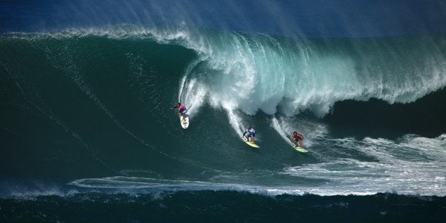 NORTH SHORE, HAWAII - DECEMBER 8: Surfers ride a wave at the Eddie Aikau Big Wave Invitational at Waimea Bay, North Shore, Hawaii on December 8, 2009 in Oahu, Hawaii. (Photo by David Gregerson/Sport Studio Photos/Getty Images)