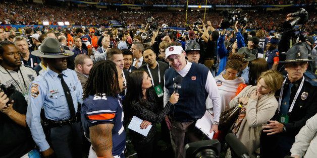 ATLANTA, GA - DECEMBER 07: head coach Gus Malzahn of the Auburn Tigers is interviewed as Tre Mason #21 of the Auburn Tigers looks on after defeating the Missouri Tigers 59-42 to win the SEC Championship Game at Georgia Dome on December 7, 2013 in Atlanta, Georgia. (Photo by Kevin C. Cox/Getty Images)