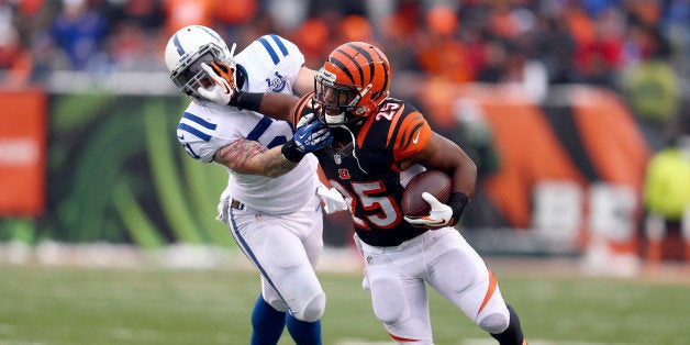 CINCINNATI, OH - DECEMBER 08: Giovani Bernard#25 of the Cincinnati Bengals runs with the ball while defended by Pat Angerer#51 of the Indianapolis Colts during the NFL game at Paul Brown Stadium on December 8, 2013 in Cincinnati, Ohio. (Photo by Andy Lyons/Getty Images)