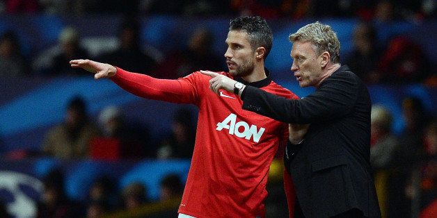 Manchester United's Scottish manager David Moyes (R) gives instructions to Manchester United's Dutch striker Robin van Persie during the UEFA Champions League football match between Manchester United and Shakhtar Donetsk at Old Trafford in Manchester, north west England on December 10, 2013. AFP PHOTO/ANDREW YATES (Photo credit should read ANDREW YATES/AFP/Getty Images)