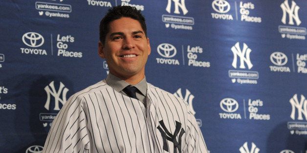 NEW YORK, NY - DECEMBER 13: Centerfielder Jacoby Ellsbury puts on his jersey during his introductory press conference at Yankee Stadium on December 13, 2013 in the Bronx borough of New York City. (Photo by Maddie Meyer/Getty Images)