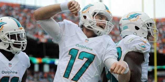 Miami Dolphins' Ryan Tannehill celebrates a touchdown to Mike Wallace in the second quarter against the New England Patriots at Sun Life Stadium in Miami Gardens, Fla., on Sunday, Dec. 15, 2013. Miami won, 24-20. (Jim Rassol/Sun Sentinel/MCT via Getty Images)