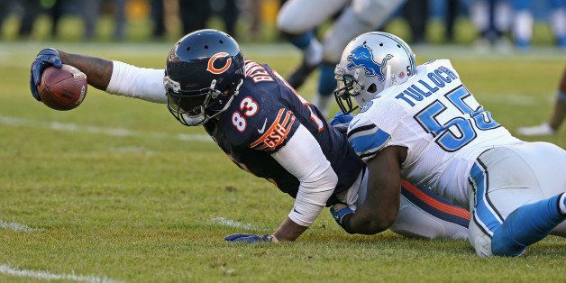 CHICAGO, IL - NOVEMBER 10: Martellus Bennett #83 of the Chicago Bears stretches after being tackled by Stephen Tulloch #55 of the Detroit Lions at Soldier Field on November 10, 2013 in Chicago, Illinois. The Lions defeated the Bears 21-19. (Photo by Jonathan Daniel/Getty Images) 