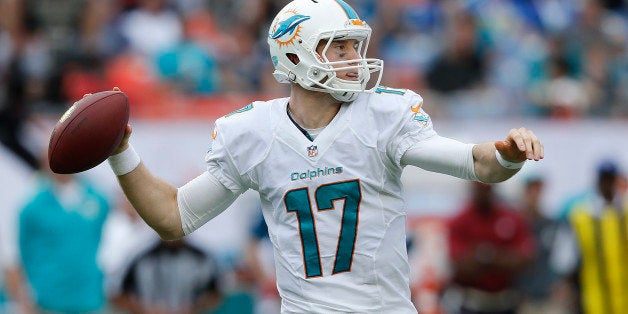 MIAMI GARDENS, FL - DECEMBER 15: Ryan Tannehill #17 of the Miami Dolphins throws the ball against the New England Patriots on