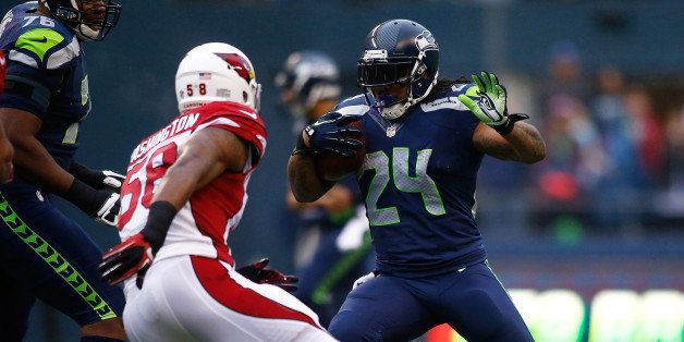 SEATTLE - DECEMBER 22: Marshawn Lynch #24 of the Seattle Seahawks runs against the Arizona Cardinals on December 22, 2013 at CenturyLink Field in Seattle, Washington. (Photo by Jonathan Ferrey/Getty Images)