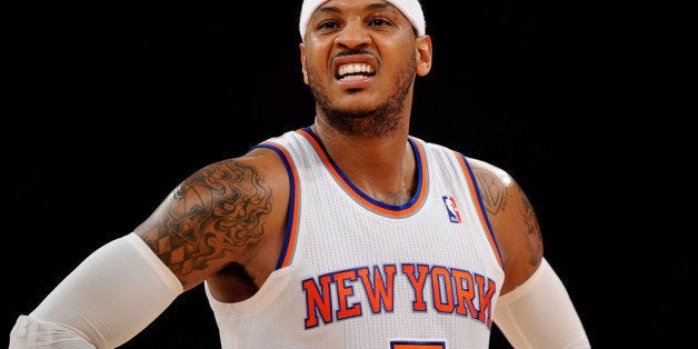 NEW YORK, NY - DECEMBER 16: Carmelo Anthony #7 of the New York Knicks looks on during the second half against the Washington Wizards at Madison Square Garden on December 16, 2013 in New York City. NOTE TO USER: User expressly acknowledges and agrees that, by downloading and/or using this photograph, user is consenting to the terms and conditions of the Getty Images License Agreement. The Wizards defeat the Knicks 102-101. (Photo by Maddie Meyer/Getty Images)