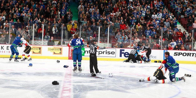 VANCOUVER, BC - JANUARY 18: A line brawl between the Vancouver Canucks and the Calgary Flames broke out at the start of their NHL game at Rogers Arena January 18, 2014 in Vancouver, British Columbia, Canada. (Photo by Jeff Vinnick/NHLI via Getty Images)