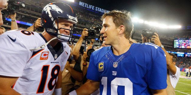 EAST RUTHERFORD, NJ - SEPTEMBER 15: (NEW YORK DAILIES OUT) Quarterbacks Peyton Manning #18 of the Denver Broncos and Eli Manning #10 of the New York Giants meet after their game on September 15, 2013 at MetLife Stadium in East Rutherford, New Jersey. The Broncos defeated the Giants 41-23. (Photo by Jim McIsaac/Getty Images) 