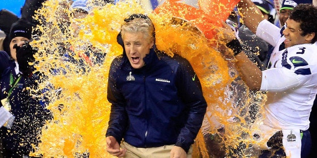 EAST RUTHERFORD, NJ - FEBRUARY 02: Tight end Zach Miller #86 and quarterback Russell Wilson #3 of the Seattle Seahawks dump Gatorade on head coach Pete Carroll in the fourth quarter of Super Bowl XLVIII against the Denver Broncos at MetLife Stadium on February 2, 2014 in East Rutherford, New Jersey. The Seattle Seahawks won 43-8. (Photo by Rob Carr/Getty Images)