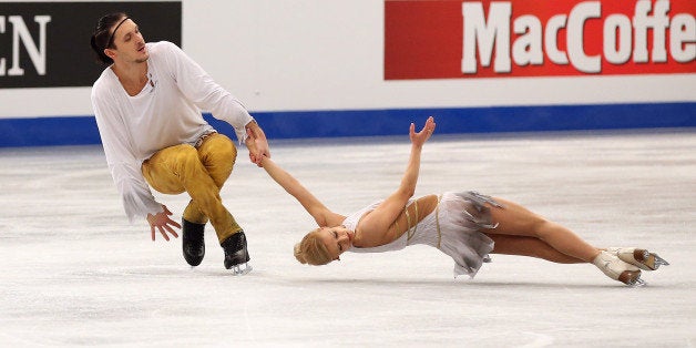 BUDAPEST, HUNGARY - JANUARY 19: Tatiana Volosozhar and Maxim Trankov of Russia (center) win the gold medal in the Pairs Skating event of the ISU European Figure Skating Championships 2014 held at the Syma Hall stadium on January 19, 2014 in Budapest, Hungary. (Photo by John Berry/Getty Images)