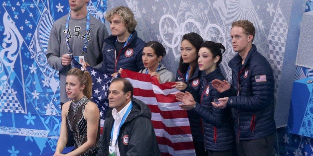 SOCHI, RUSSIA - FEBRUARY 08: Ashley Wagner of the United States waits for her score with teammates and coaches during the Figure Skating Team Ladies Short Program during day one of the Sochi 2014 Winter Olympics at Iceberg Skating Palace on February 8, 2014 in Sochi, Russia. (Photo by Matthew Stockman/Getty Images)