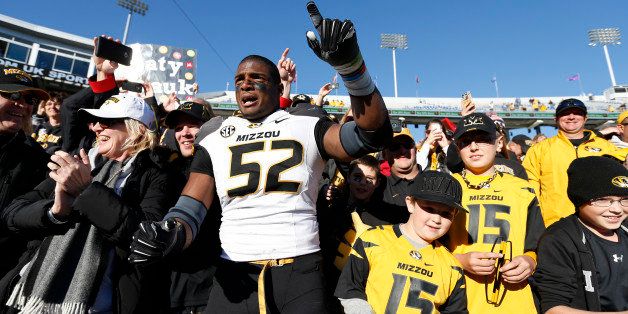 LEXINGTON, KY - NOVEMBER 9: Michael Sam #52 of the Missouri Tigers celebrates with fans after the game against the Kentucky Wildcats at Commonwealth Stadium on November 9, 2013 in Lexington, Kentucky. Missouri won 48-17. (Photo by Joe Robbins/Getty Images)