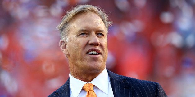 DENVER, CO - JANUARY 19: John Elway, executive vice president of football operations for the Denver Broncos, celebrate after they defeated the New England Patriots 26 to 16 in the AFC Championship game at Sports Authority Field at Mile High on January 19, 2014 in Denver, Colorado. (Photo by Elsa/Getty Images) 