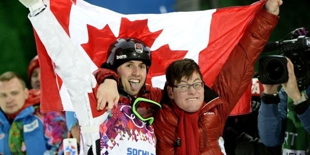 Canada's Alex Bilodeau celebrates his gold medal with his brother Frederic at the Men's Freestyle Skiing Moguls final at the