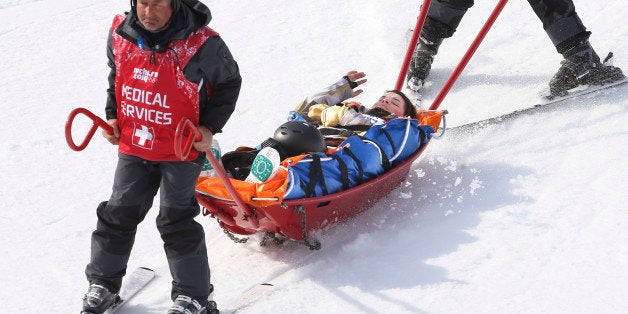 Sochi, Russia - February 16 - SSOLY- American Jacqueline Hernandez gets brought down the hill after a crash in qualifiers.At the Winter Olympics in Sochi, Canadian Dominique Maltais won silver in the women's snowboard cross at the Rosa Khosta extreme park.February 16, 2014 (Richard Lautens/Toronto Star via Getty Images)