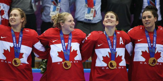 SOCHI, RUSSIA - FEBRUARY 20: Gold medalists Brianne Jenner #19, Haley Irwin #21, Hayley Wickenheiser #22 and Natalie Spooner #24 of Canada celebrate during the medal ceremony after defeating the United States 3-2 in overtime during the Ice Hockey Women's Gold Medal Game on day 13 of the Sochi 2014 Winter Olympics at Bolshoy Ice Dome on February 20, 2014 in Sochi, Russia. (Photo by Bruce Bennett/Getty Images)