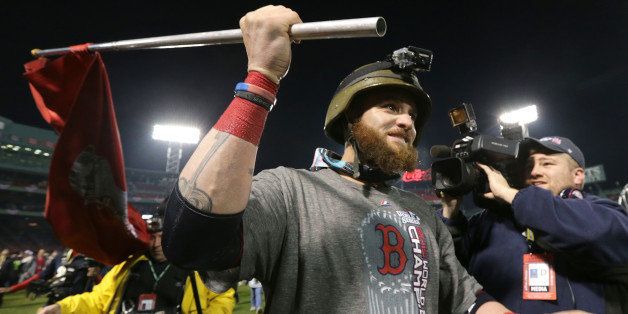 BOSTON - OCTOBER 30: Boston Red Sox left fielder Jonny Gomes (#5) waves the championship flag as he celebrates on the field at the end of the game. The Boston Red Sox host the St. Louis Cardinals at Fenway Park for Game Six of the 2013 Major League Baseball World Series, Oct. 30, 2013. (Photo by Barry Chin/The Boston Globe via Getty Images)