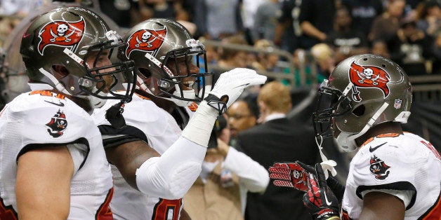 NEW ORLEANS, LA - DECEMBER 29: Tight end Timothy Wright #81 of the Tampa Bay Buccaneers celebrates with teammates after catching a touchdown pass against the New Orleans Saints in the first half of play at the Mercedes-Benz Superdome on December 29, 2013 in New Olreans, Louisiana. The Saints defeated the Buccaneers 42-17. (Photo by David K Purdy/Getty Images)